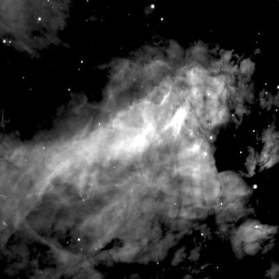 A large, shapeless cloud in shades of grey with some white patches takes up most of the image. Around the edges, especially in the upper left, there is a black background visible with some white dots of stars.