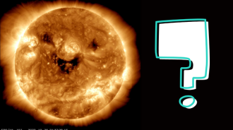 An image of the Sun closer up. There are 3 large dark patches on it that look like a smiling face. There is a large question mark to the right of the Sun.